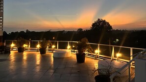 A rooftop terrace with potted plants and a railing. - Apartment in Coronado: Just steps from the beach, restaurants, cafes, and bars (Las Lajas)