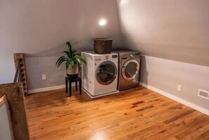 Convenient laundry facilities with two washing machines and a dryer.