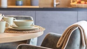 A modern kitchen with a dining area.