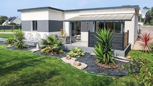A modern two-story house with a patio area, outdoor seating, and a well-maintained garden. - Palet Breton by Interhome (Locquirec)
