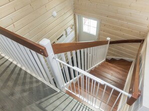 A wooden interior with a white railing and a small window. - South point apartments 4a by Interhome (Kittilä)
