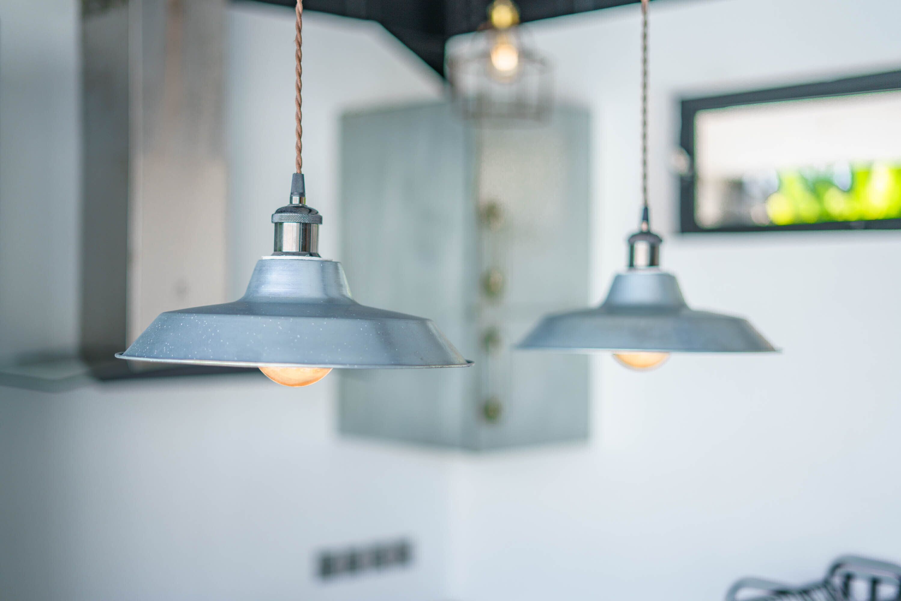 Two pendant lights hanging from the ceiling in a modern interior.