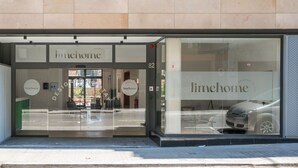 A building with a glass storefront labeled "limehome". - Limehome Barcelona Carrer de Besalú 82 (Barcelona)
