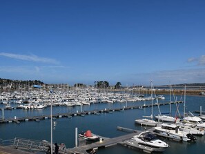 Boats docked at the marina, surrounded by calm waters and a serene landscape.