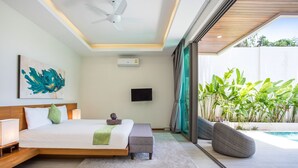 A modern bedroom with a large bed, a ceiling fan, a flat-screen TV, and a view of a swimming pool and greenery. - Trendy 4BR Villa Kari in KA Villas Rawai (Rawai)
