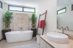 A modern bathroom with a freestanding bathtub, a large sink, and two potted plants. - Trendy 4BR Villa Kari in KA Villas Rawai (Rawai)