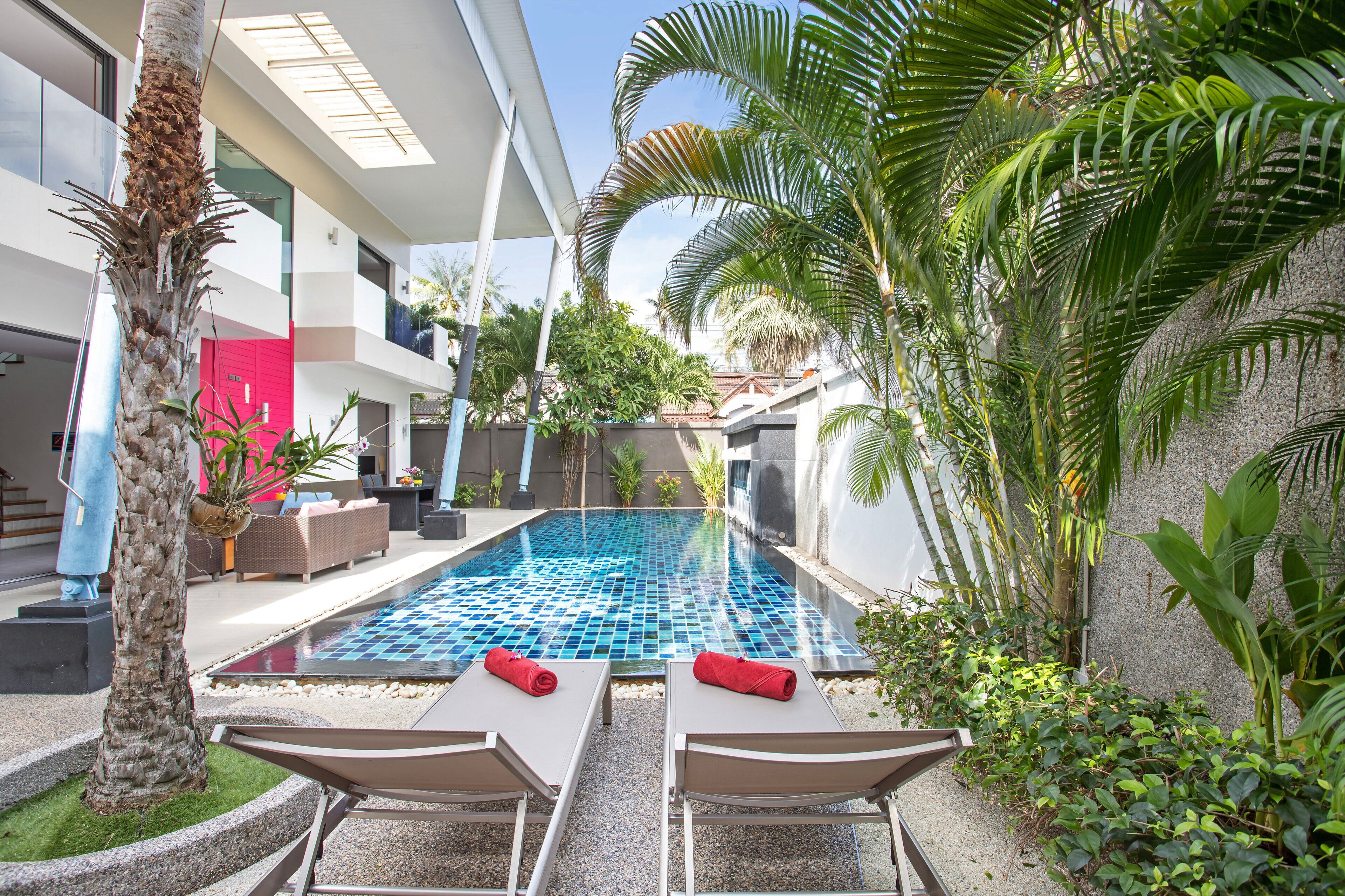 A modern pool area with lounge chairs and a tiled pool.