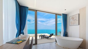 A modern bathroom with a freestanding bathtub, a wooden vanity, and a view of the ocean. - Villa The Wave 2 Residence (Koh Samui)