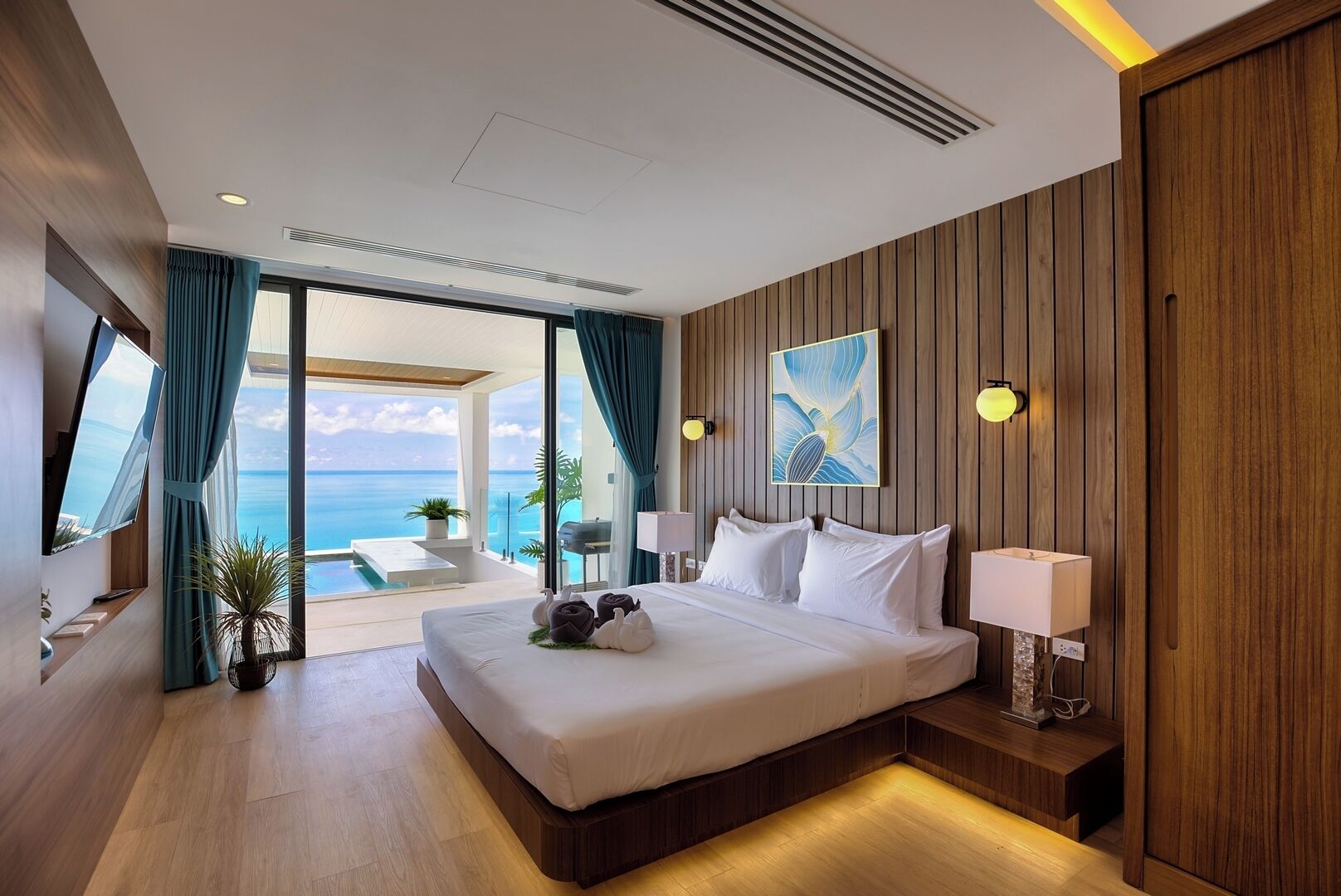 A modern hotel room with a large bed, a view of the ocean, wooden paneling, and a balcony with a pool.