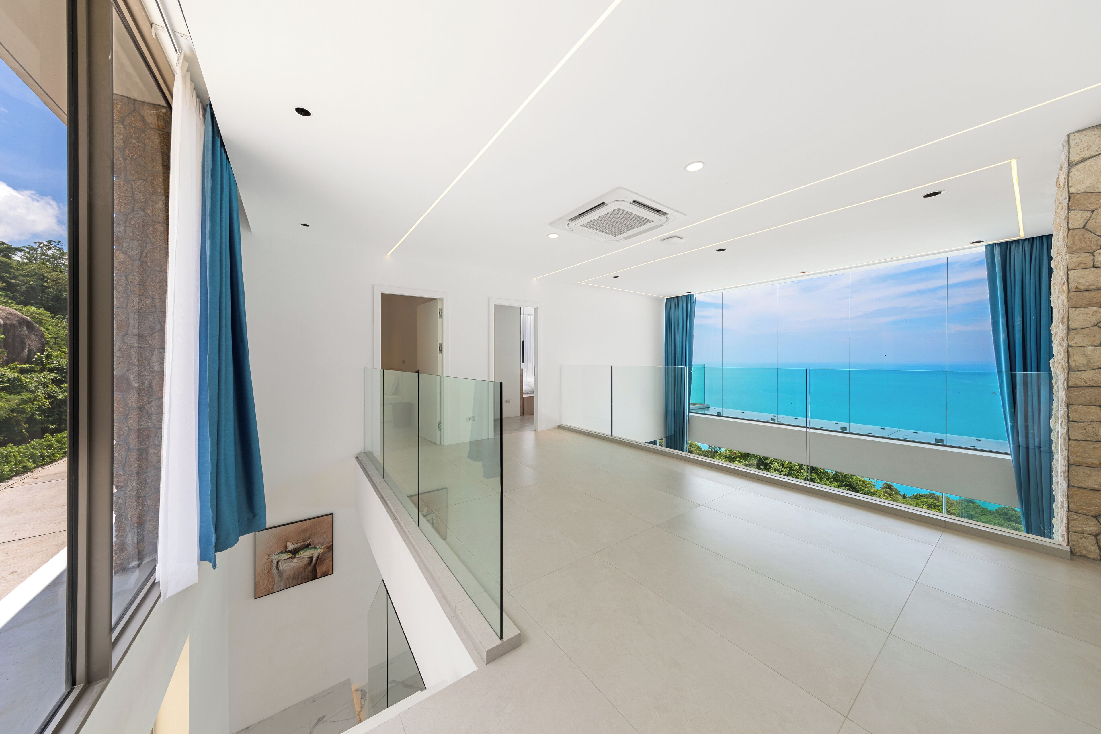 A spacious room with a large window overlooking a scenic view.