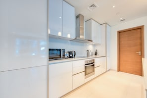 Luxury Apartment, City View | Private kitchen | Dining tables