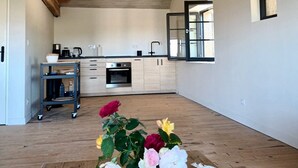 A spacious kitchen with modern appliances, a wooden ceiling, and a small window. - Spacious 'Adults Only' loft surrounded by nature (Crespin)