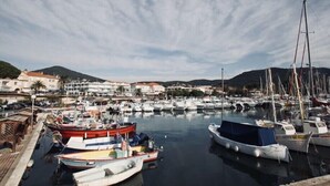 A marina with boats docked, buildings in the background, and a clear sky. - Air-conditioned studio with parking and close to the sea. (Carqueiranne)