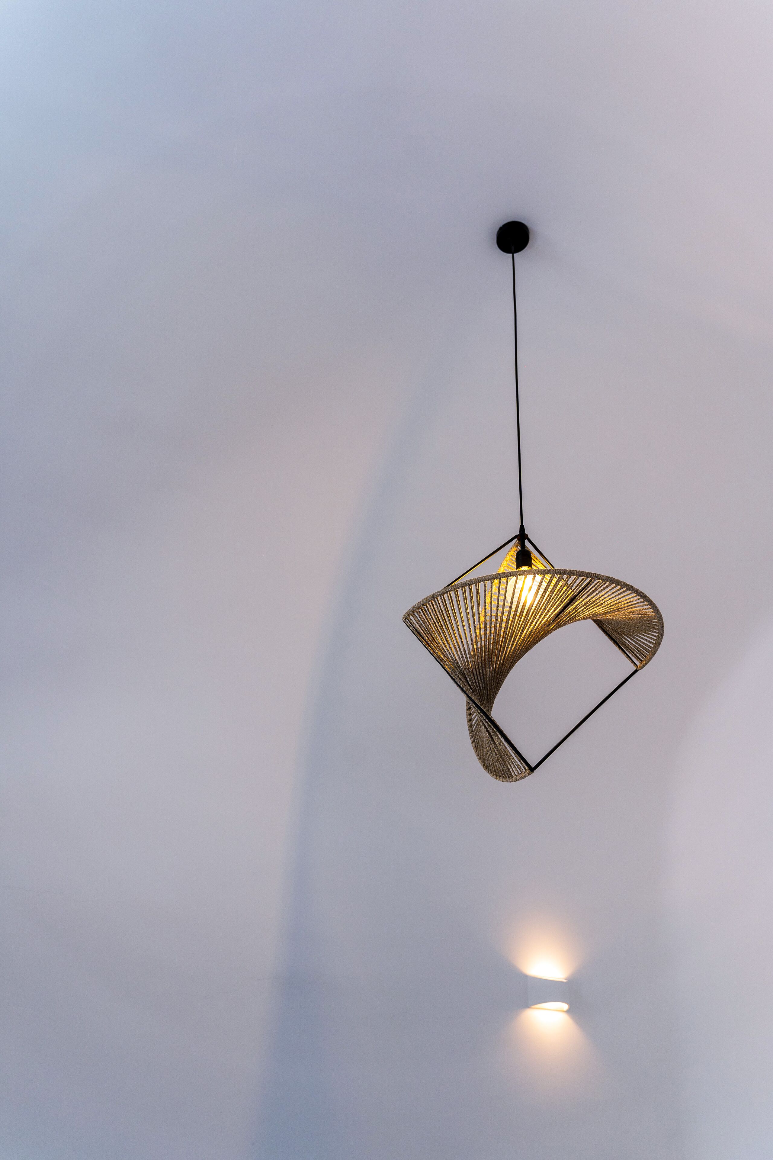 A pendant light with a geometric design hanging from a ceiling.