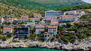 A coastal town with buildings on a hillside overlooking the sea. - Villa Key private sea access and great views of the Adriatic sea (Zaton)