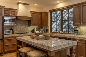 Enjoy cooking in this well-equipped kitchen with a central island and modern appliances.
