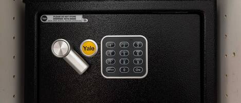 A Yale safe deposit box with a combination lock and a key.