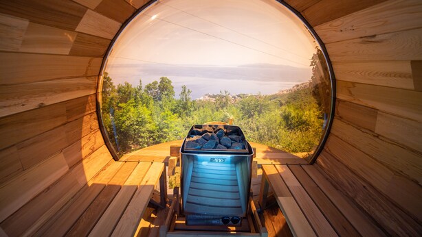A circular wooden structure with a view of a landscape through a large window. - Bela Vista 4 (Bregi)