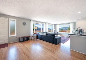 Relax in this inviting living space with a large sofa, mountain view, and cozy seating area.