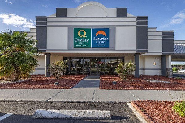 A hotel entrance with a sign for Quality Inn and Suburban Studios. - Suburban Studios Rock Hill Northeast I-77 (Rock Hill)
