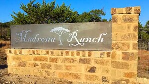 A sign for Madrona Ranch with a tree graphic. - Romantic Bungalow "Carmen" on 30 Acres (Dripping Springs)