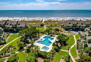 A resort with a central pool, beachfront view, and multiple green-roofed buildings. - Newly Remodeled Bathrooms - 8D Mariners Walk - Ocean Views - Wild Dunes (Isle Of Palms)