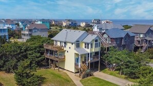 A coastal residential area with houses featuring balconies and waterfront views. - Oceanside Dog Friendly Home w/ Hot Tub, Game Room, and Wet Bar. Island Stylin'! (Frisco)