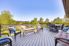 A wooden deck with wicker furniture, including sofas and chairs, and a table. - Hot Tub! Mtn-View Family Haven in Black Forest (Colorado Springs)