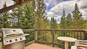 A deck with a stainless steel grill, a round table, and chairs. - Walk to Ski Lift: Breckenridge Retreat w/ 2 Decks! (Breckenridge)