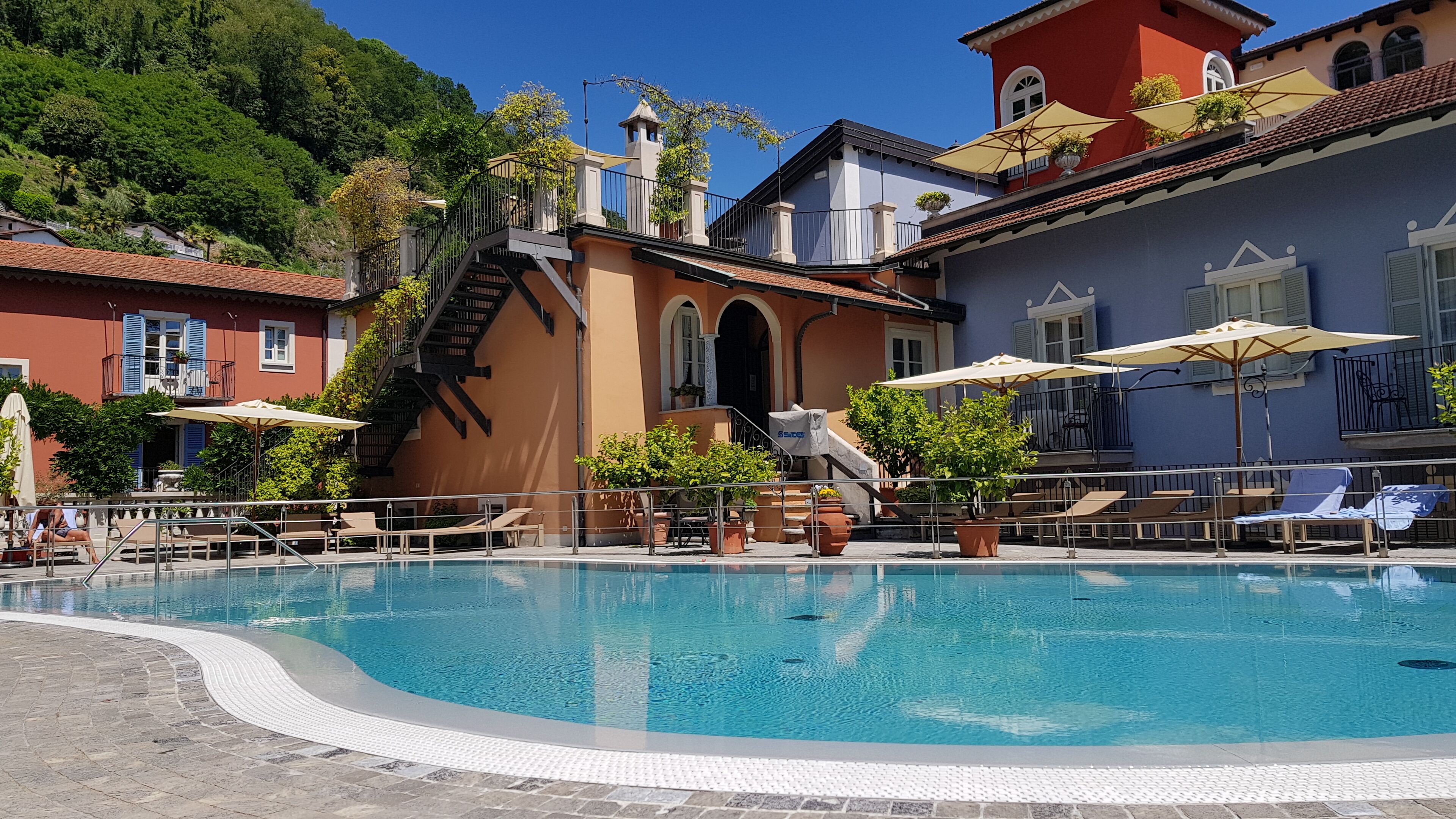 Seasonal outdoor pool, open 8:00 AM to 7:00 PM, pool umbrellas