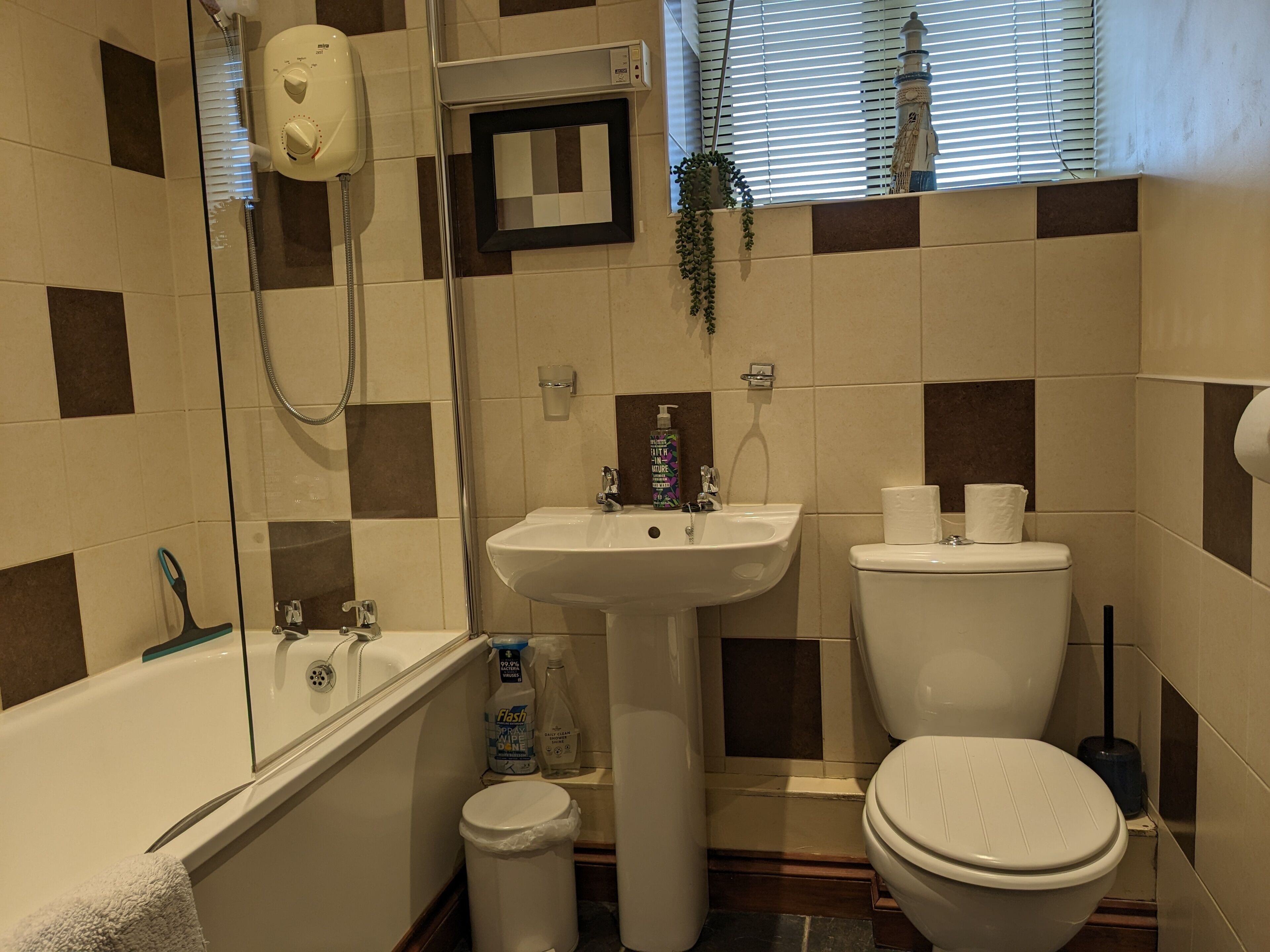 A bathroom with a bathtub, sink, toilet, and a shower.