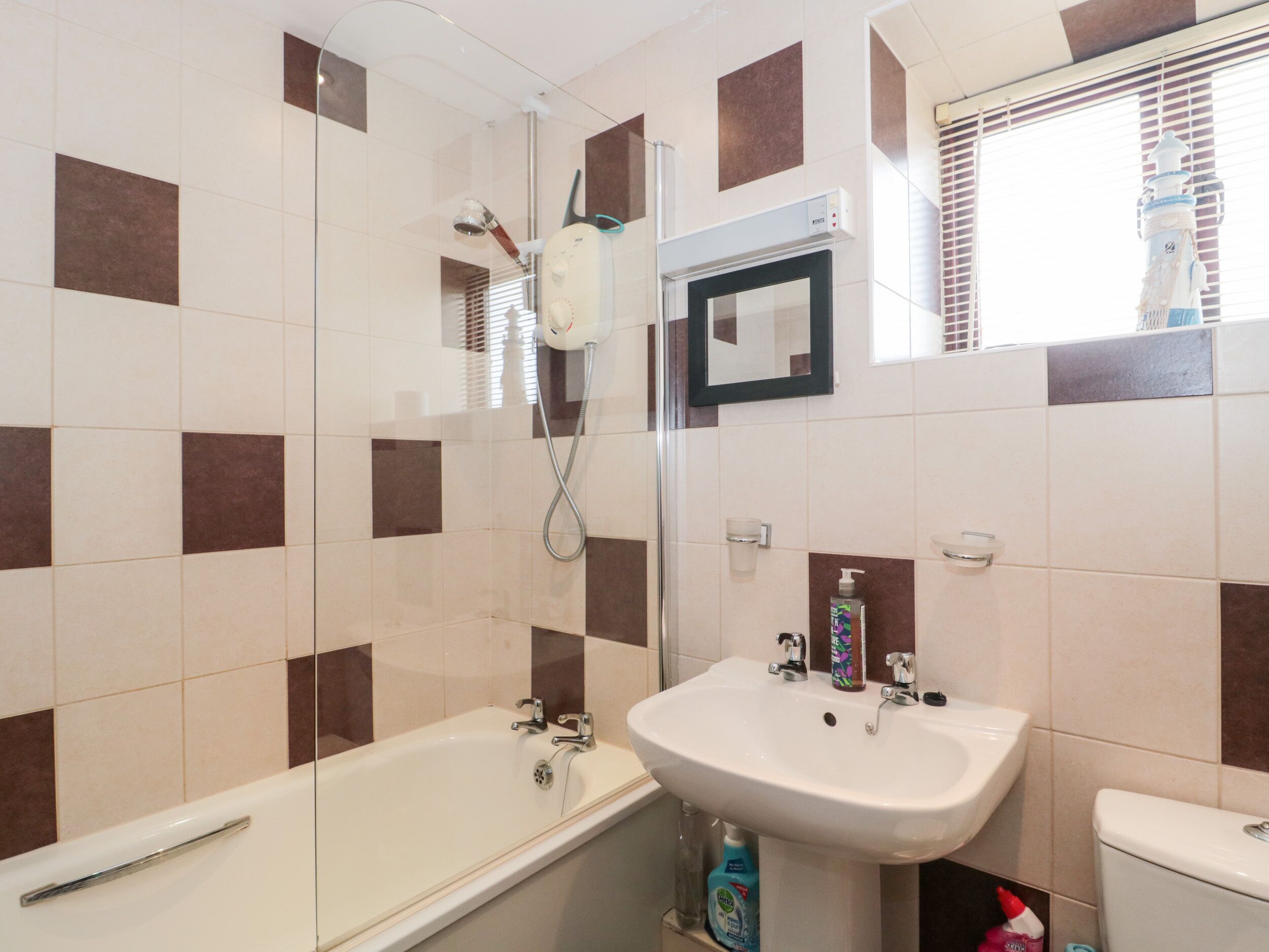 A bathroom with a bathtub, a sink, and a shower.