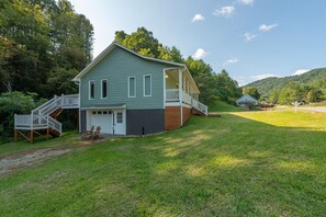 A two-story house with a front porch, a staircase, and a garage. - Hot Tub+Fire Pit, WiFi, Close to AVL+Burnsville! Perfect Location! Easy Access! (Burnsville)