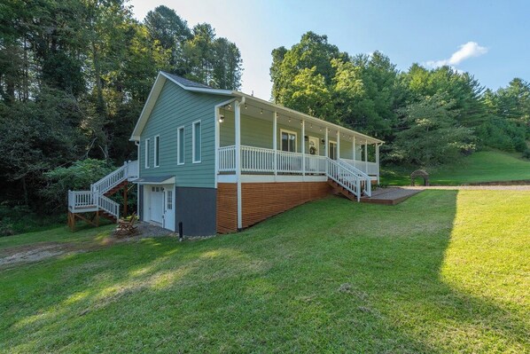 A two-story house with a porch, a staircase, and a small deck. - Cozy Cottage~Hot Tub+Fire Pit+Grill~WiFi~Near AVL! (Burnsville)