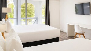 A modern hotel room with two beds, a desk, a chair, a TV, and large windows with curtains. - Oneway Savannah (Savannah)