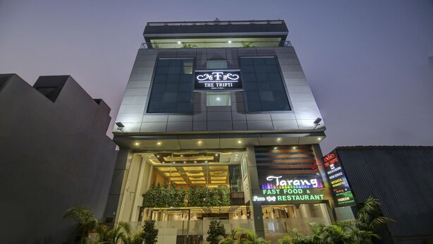 A modern building with a sign for 'The Tripti' and 'Tarang Fast Food & Restaurant'. - The Tripti Hotel (Indore)