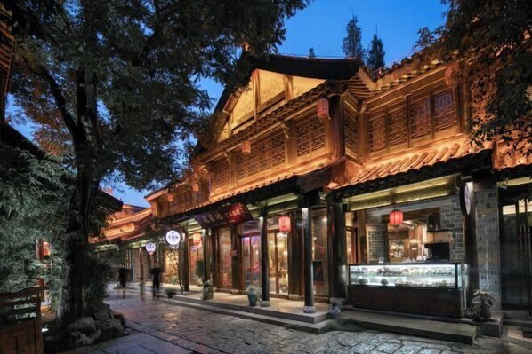 A traditional wooden building with a tiled roof and a glass display case.