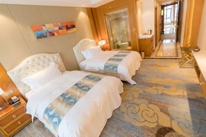 A hotel room with two beds, a large mirror, a painting on the wall, and a carpet with a cloud pattern. - Textile City Hotel (Nantong)