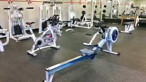 A gym with various exercise equipment, a wall clock, and a logo for 'SWIM & TENNIS CLUB'.