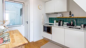 Fridge, microwave, stovetop, coffee/tea maker