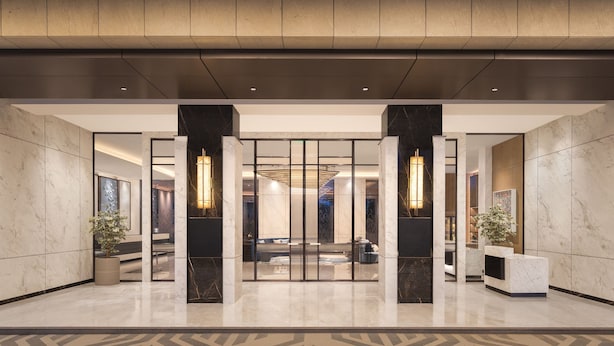 A modern lobby with marble flooring, a reception desk, and a seating area. - Fairfield by Marriott Mumbai International Airport (Mumbai)