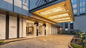 A modern hotel entrance with a spacious lobby, a prominent marquee sign, and a well-lit outdoor area. - Fairfield by Marriott Mumbai International Airport (Mumbai)