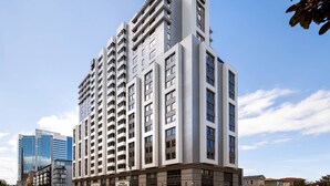 A high-rise hotel with multiple floors, large windows, and a modern architectural design. - Residence Inn by Marriott Oakland Downtown (Oakland)
