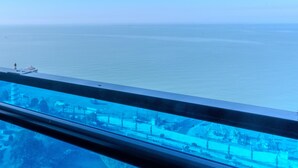 A view from a balcony overlooking a calm sea with a distant shoreline. - ORBI CITY Hotel Sea View (Batumi)