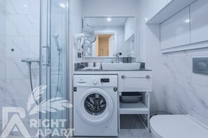 Family Apartment, 1 Bedroom | Bathroom | Shower, hair dryer, slippers, towels - ORBI CITY Hotel Sea View (Batumi)