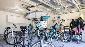 A garage with bicycles and a surfboard. - Family Friendly, Great Pool and Easy Bowman's Beach Access (Sanibel)