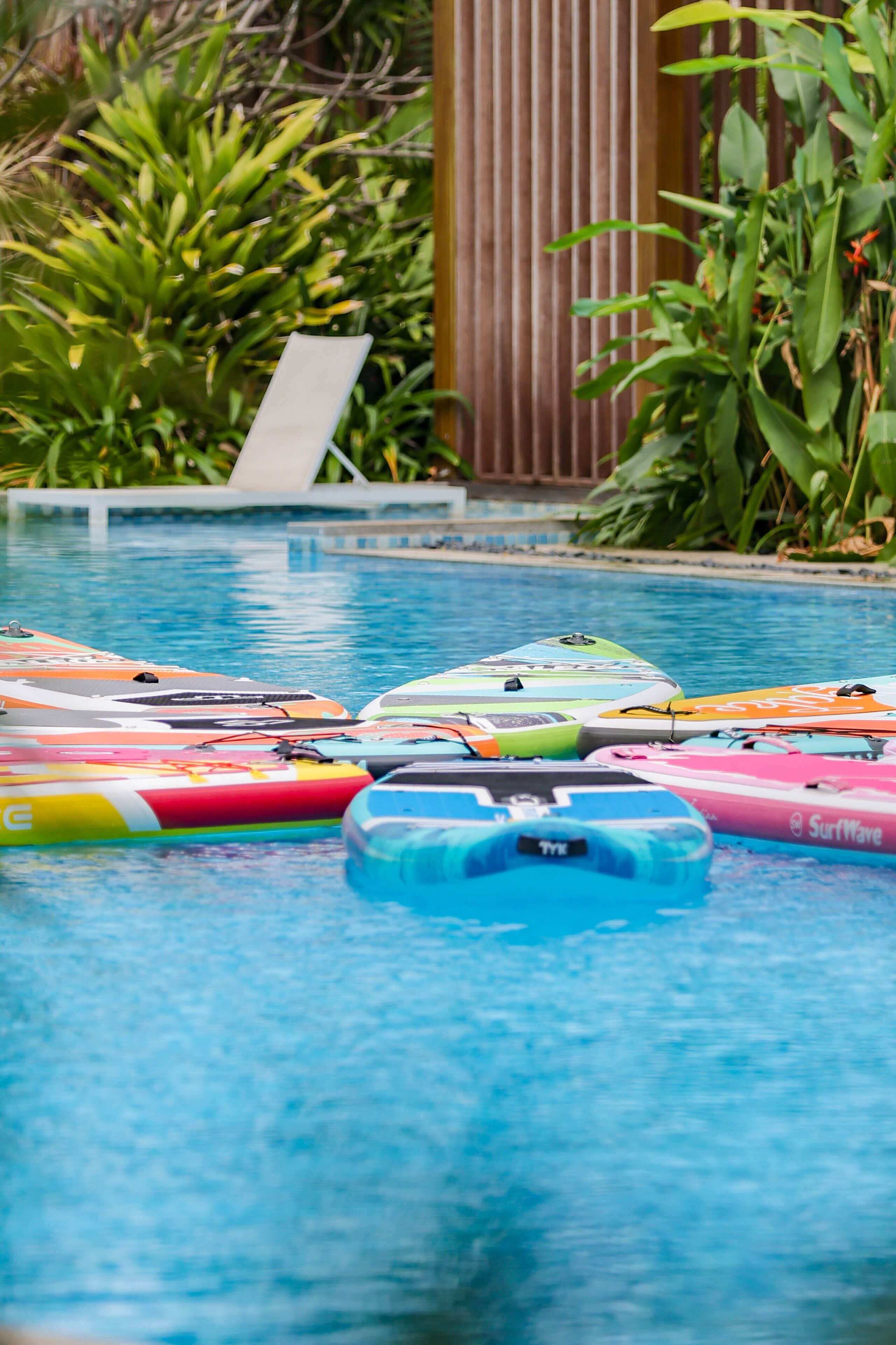 A swimming pool with various colorful inflatable toys.