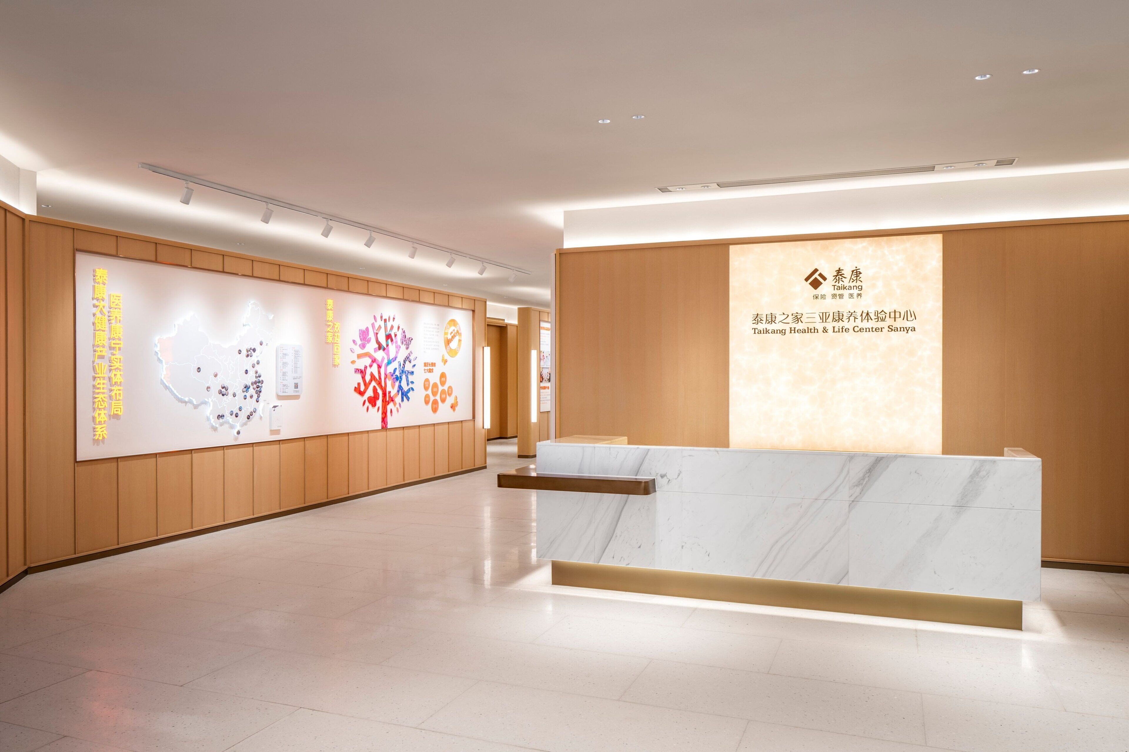 A modern reception area with a marble counter and wooden paneling.