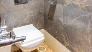 A bathroom with a toilet, a shower, and a sink. - HOTEL RUBY (Mumbai)