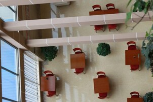 A spacious indoor area with multiple tables and chairs, arranged in a grid pattern.